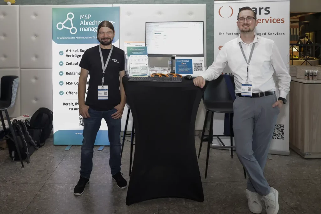 Zwei Mitarbeiter am Stand von mars services und MSP Abrechnungsmanager auf dem NMS Symposium